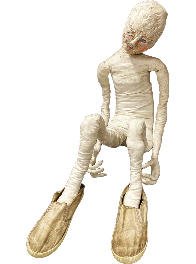 A sculpted human figure with oversized slippers