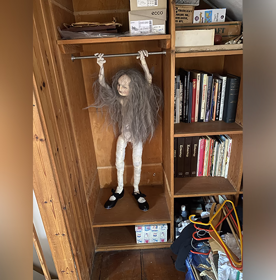 Hanging doll inside a wardrobe