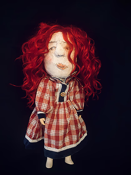 Uncanny girl doll in checkered dress with long red wavy hair