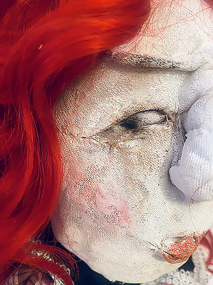 Uncanny girl doll with long red wavy hair