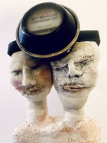 Double headed skeletal torso crowned with a vintage mechanical hubodometer