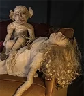 Small view of a demon sitting on a sleeping woman