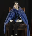 Human sculpture of a man in blue cloak